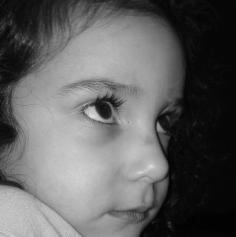 Asma as a child looking over her shoulder