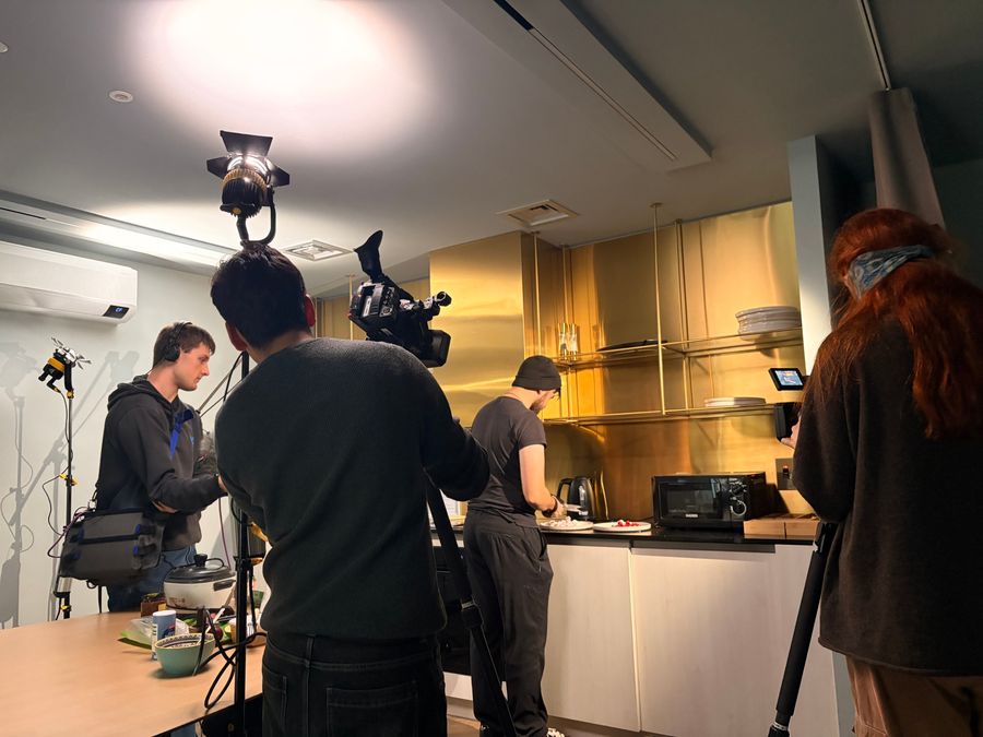 Behind the scenes on On Air: crew lighting and filming the cooking segment
