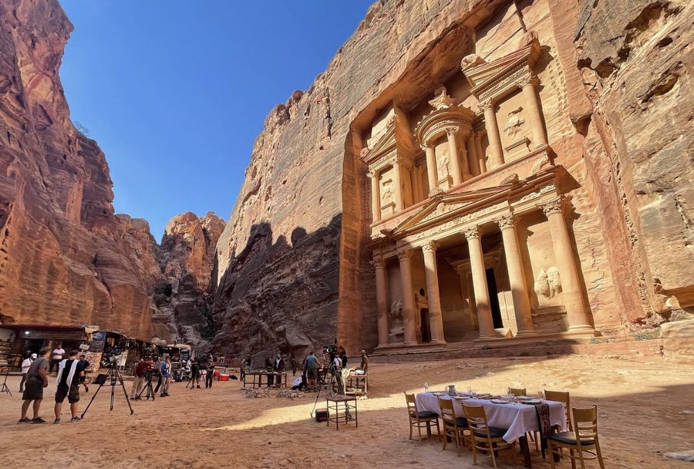 Behind the scenes on Uncharted: the crew setting up a dinner table in front of the Treasury at Petra